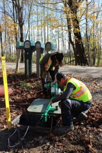 Two field techs preparing to start pulling fibre in Clayton, Ontario.